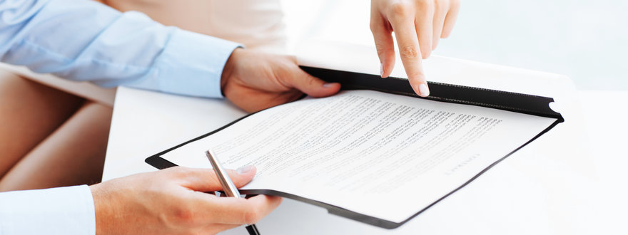 Two business people signing a document